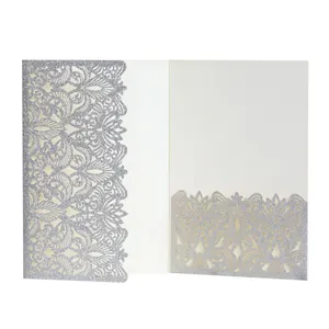 Detail of elegant silver glitter laser-cut invitation card with intricate floral pattern.