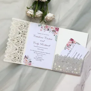 Detail of elegant laser-cut wedding invitation set with silver glitter pocket