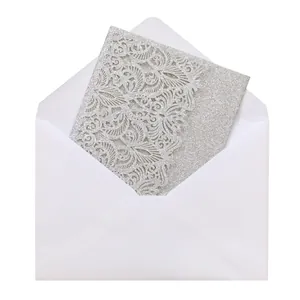 Detailed view of silver glitter laser-cut invitation card with intricate floral patterns