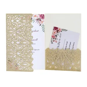 Detail of laser-cut glitter gold wedding invitation with floral insert and RSVP card.