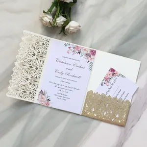 Detailed view of elegant laser-cut floral wedding invitation with gold glitter accents