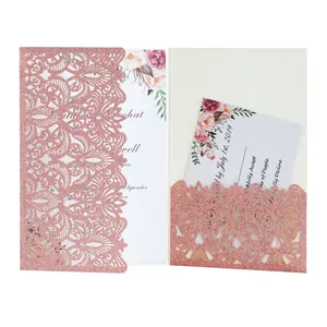 Detail of rose gold glitter laser-cut invitation card with floral pattern inserts