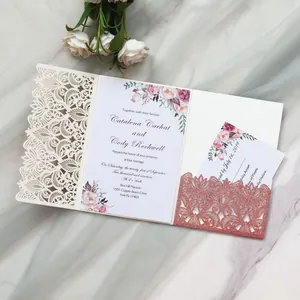 Close-up of laser-cut floral wedding invitation with glitter detail and cards