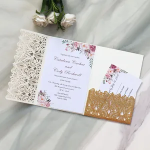 Detailed view of elegant laser-cut floral wedding invitation with gold glitter pocket