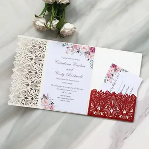 Detailed view of elegant laser-cut floral wedding invitation with red glitter pocket