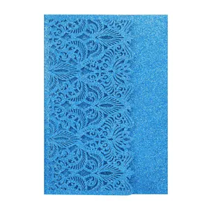 Detailed view of the intricate laser-cut blue glitter lace pattern on a premium invitation card