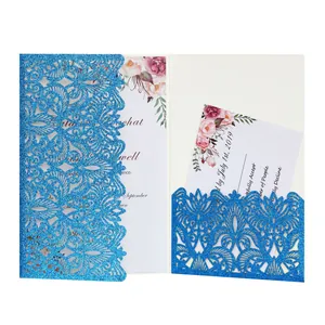 Elegant blue laser-cut wedding invitation with glitter finish and floral inner cards