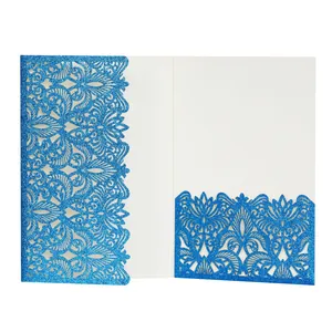 Detailed macro view of intricate laser-cut blue glitter invitation card pocket for weddings