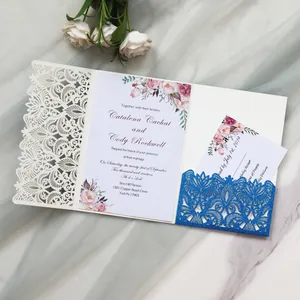 Detailed view of a laser-cut wedding invitation with blue glitter pocket and floral design.
