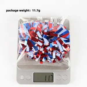 Macro view of Independence Day red white blue tinsel wrist flower being weighed