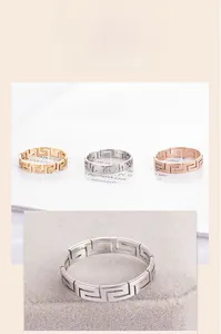 Detailed close-up showing the hollowed Greek key pattern on a titanium steel ring band