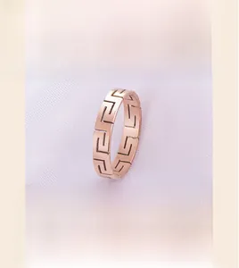 Macro view of a rose gold plated stainless steel ring with hollow meander pattern