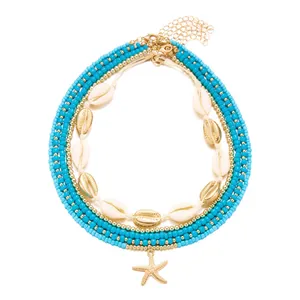 Detailed view of bohemian multi-layer necklace set with shells and starfish pendant.