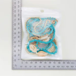 Bohemian multi-layer beaded shell necklace set shown in zip bag with measurement scale