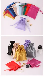 Close-up of colorful satin drawstring gift pouches for jewelry packaging and silk texture