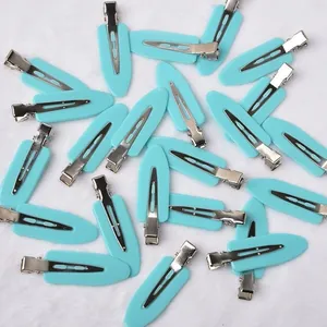 Close-up of light blue creaseless duckbill hair clips for professional styling