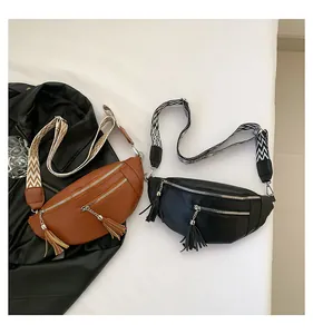 Detailed view of fashionable PU leather chest bags featuring tassels and patterned straps.