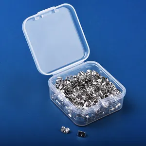 Detail view of silver butterfly earring backs stored in a clear plastic organizer box