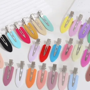 Detailed view of colorful no-trace duckbill hair clips in various pastel shades