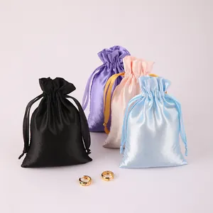 Assorted colorful satin drawstring gift bags for elegant jewelry packaging and storage.