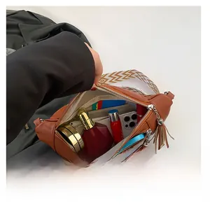 Detailed view of the brown PU leather chest bag interior showing storage capacity