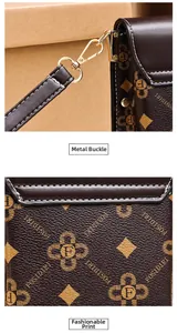 Primo piano del gancio in oro e dell'elegante stampa monogramma sulla borsa marrone.