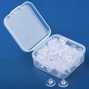 Detailed view of transparent rubber earring backs stored in a clear plastic organizer box
