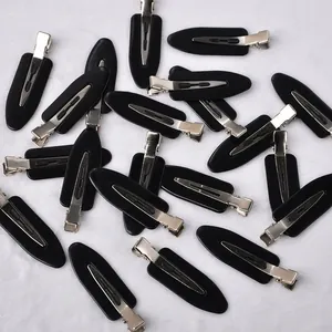 Macro view of black no-crease hair clips with silver metal duckbill clamps