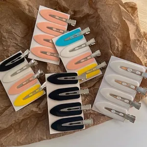 Macro detail of various colorful seamless duckbill hair clips on paper background