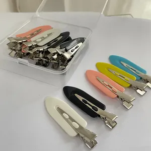 Detailed view of colorful traceless duckbill hair clips arranged with a clear storage box
