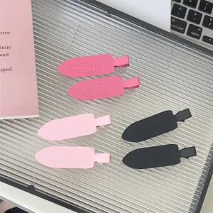 Set of six seamless plastic blade hair clips in assorted pink and black colors for women.