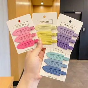 Set of colorful seamless duckbill hair clips on display cards for women's hair styling