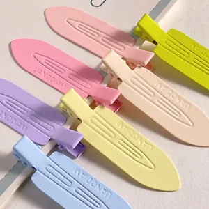 Detail showing variety of colorful matte no-crease alligator hair clips in soft pastel tones