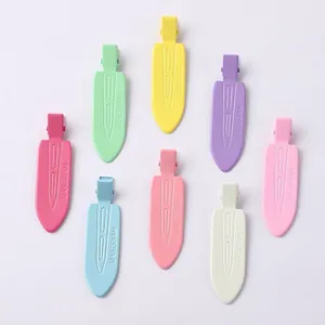 Detailed macro view of eight colorful matte no-crease duckbill hair clips for styling