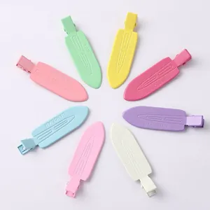 Close-up of seven colorful seamless duckbill hair clips in pastel macaron shades