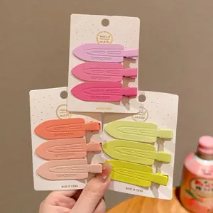 Macro detail of matte plastic creaseless hair clips in various pastel colors on cards