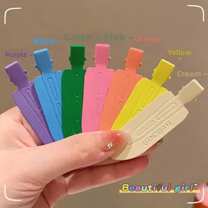 Detail of seamless colorful plastic duckbill hair clips set in matte finish