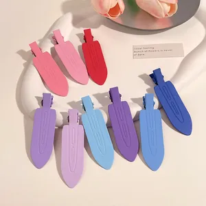 Detail view of colorful matte no-trace duckbill hair clips for fringe styling