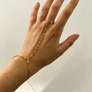 Detailed view of a gold-plated stainless steel hand chain with a connected ring.