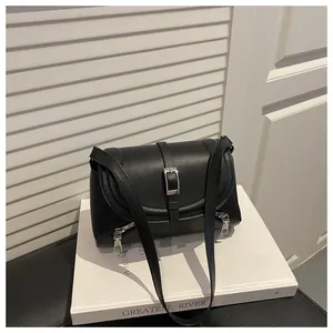 Detailed view of the black retro shoulder bag with silver buckle and zipper accents