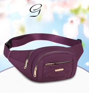 Close-up detail of a purple multi-layer nylon waist bag with quilted floral patterns and gold zippers