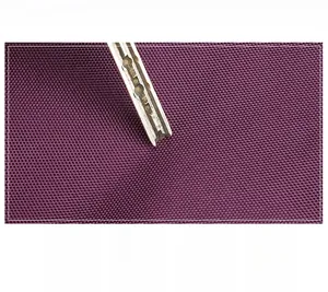 Detailed close-up showing the durable purple fabric texture and scratch resistance feature