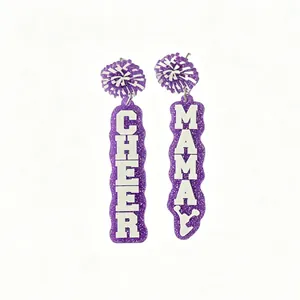 Close-up of purple glitter acrylic earrings featuring white Cheer Mama lettering
