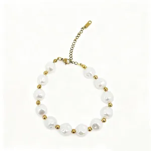 Close-up of baroque pearl bracelet with gold-toned spacer beads and lobster clasp