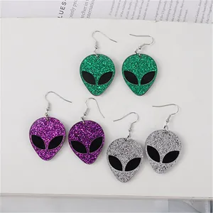 Close-up of glitter alien head drop earrings in green, purple, and silver colors.