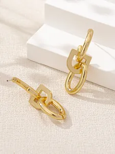 Detail showing the interlocking oval and D-shaped gold links of these minimalist earrings.