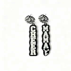 Close-up of black glitter acrylic earrings with 'Cheer' and 'Mama' printed lettering