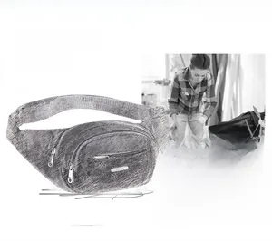 Detailed view of the grey textured multi-layer women's waist bag with silver zippers