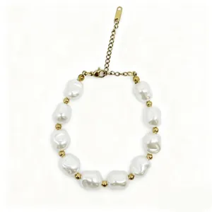 Close-up detail of baroque irregular pearl bracelet with gold spacer beads and chain