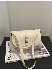 Elegant vintage cream faux leather crossbody bag with buckle detail and front zippers